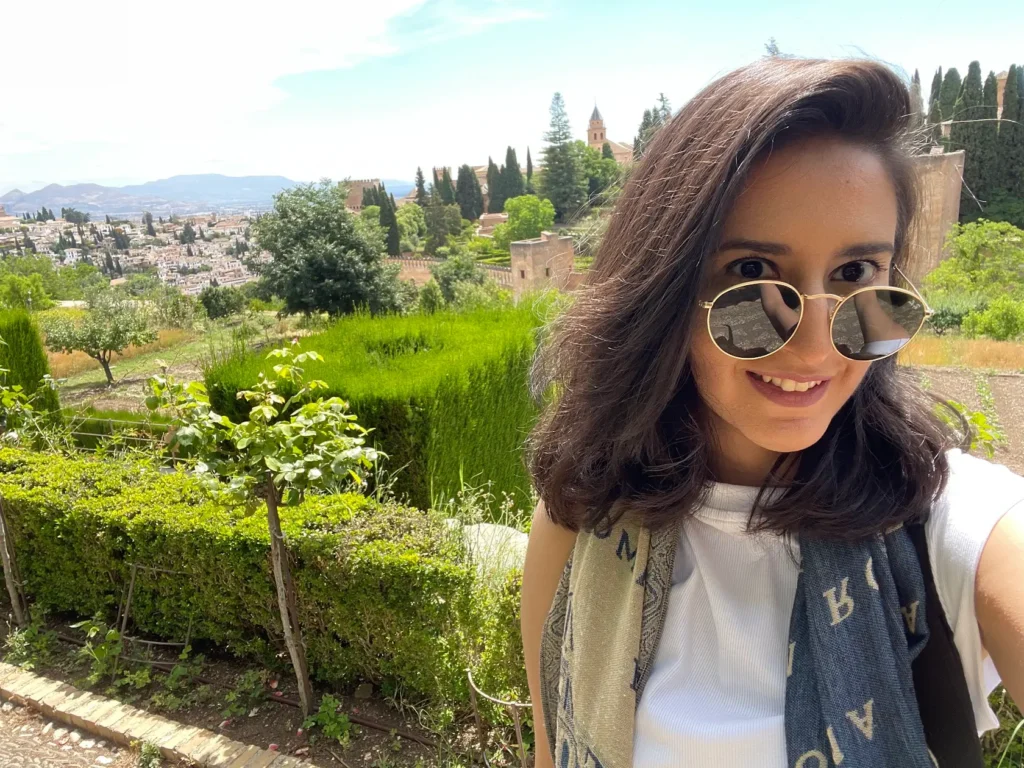 selfie of blogger against the backdrop of alhambra, granada, spain on her europe trip as a solo female traveller